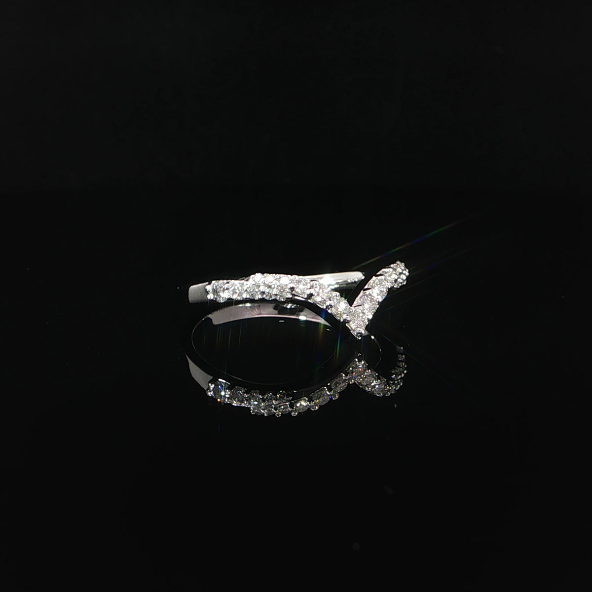 Angled view of a white gold contour band with round lab-grown diamonds and polished shoulders.
