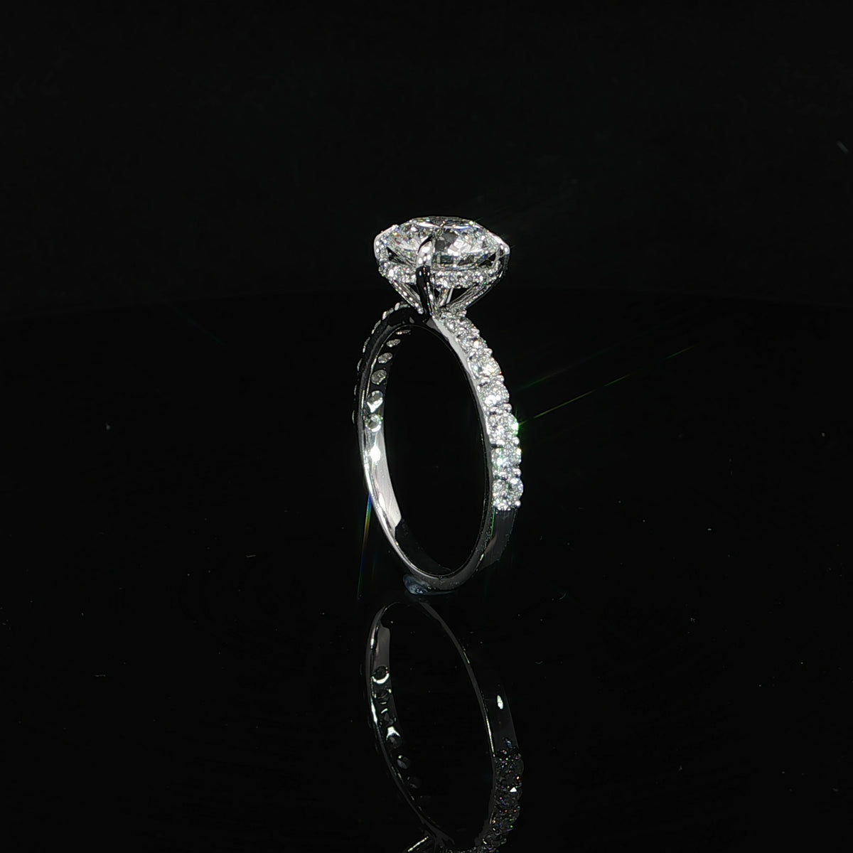 Side profile showing the hidden diamond halo beneath the round lab-grown center stone.