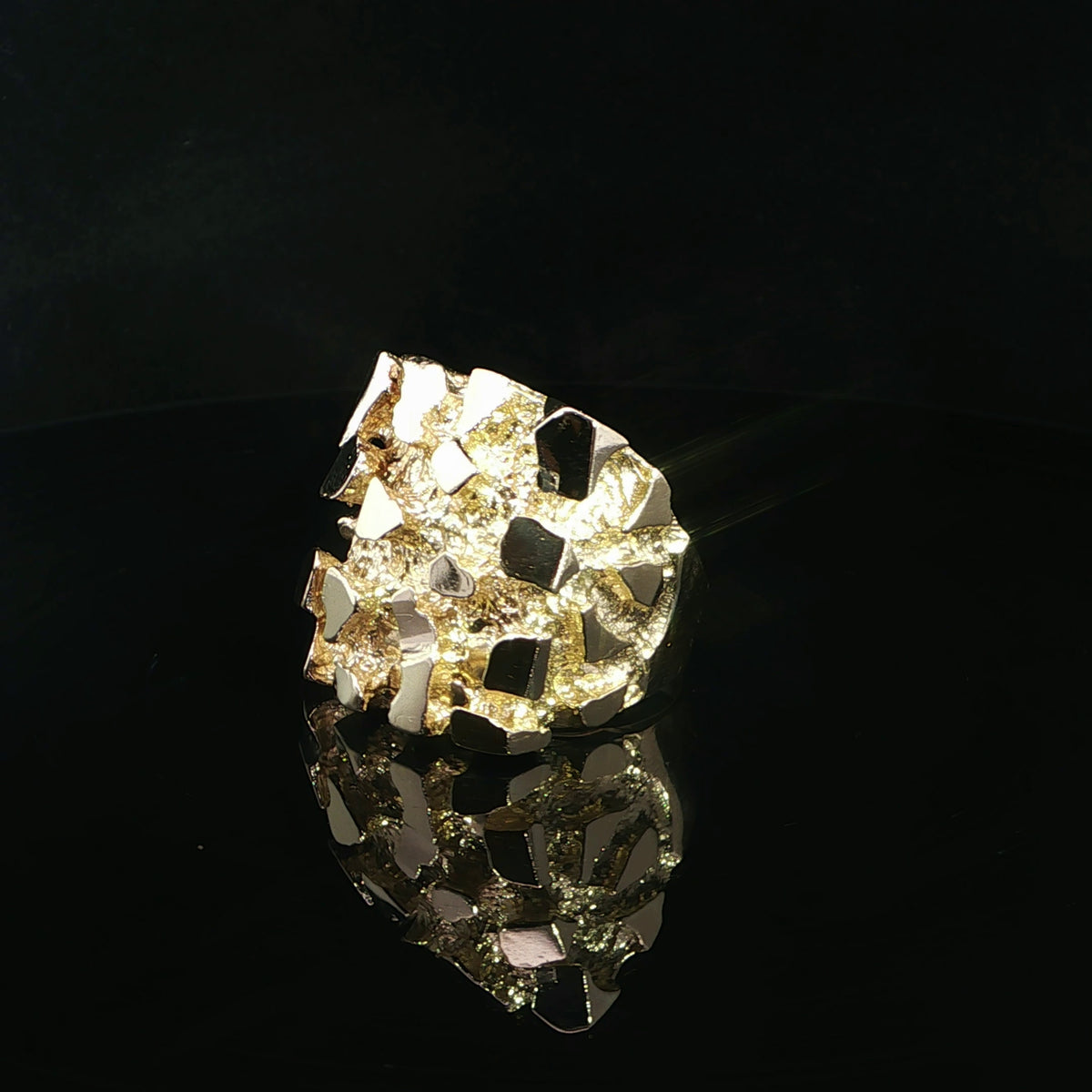 Yellow gold nugget ring measuring 27 x 28 mm, shown at an angle on a reflective black surface.