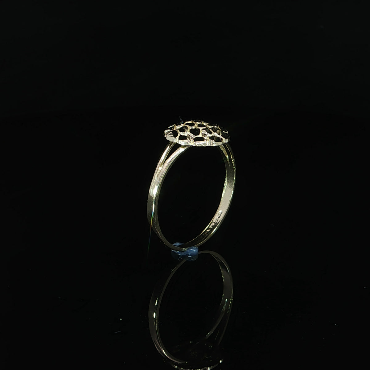 Side profile of a yellow gold split-shank ring showing the circular nugget top above a narrow band.