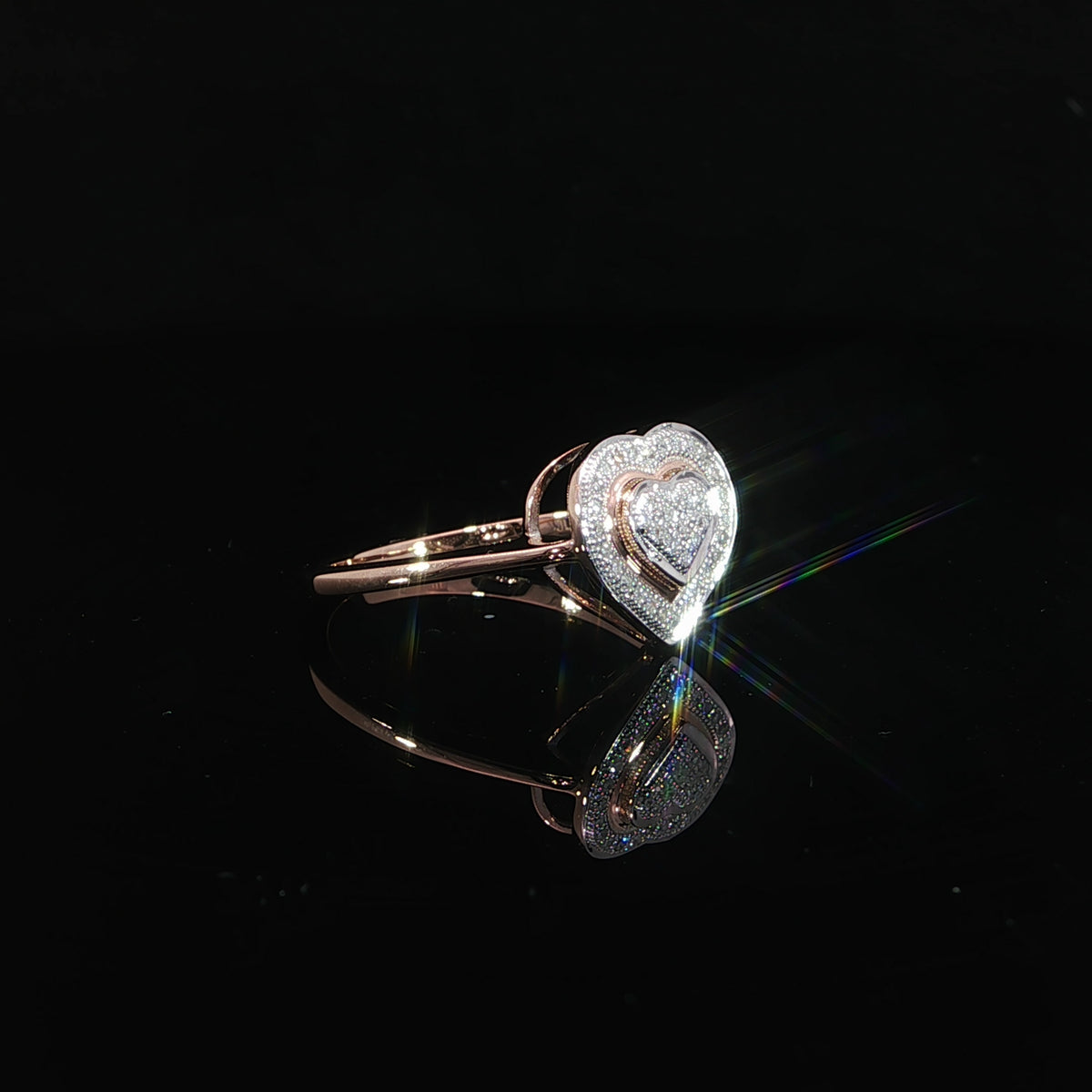 Side profile of a 10K rose gold 0.10 CTW diamond promise ring with an open supporting gallery.