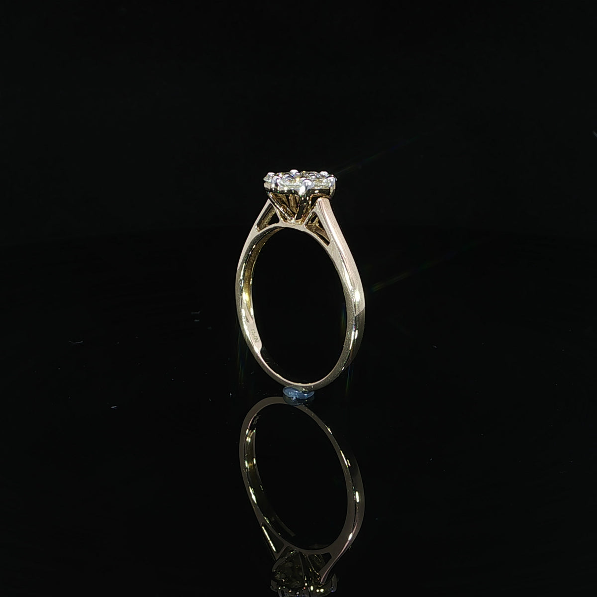 Upright profile of a 10K yellow gold 0.50 CTW seven-diamond ring showing the open supports beneath the cluster.