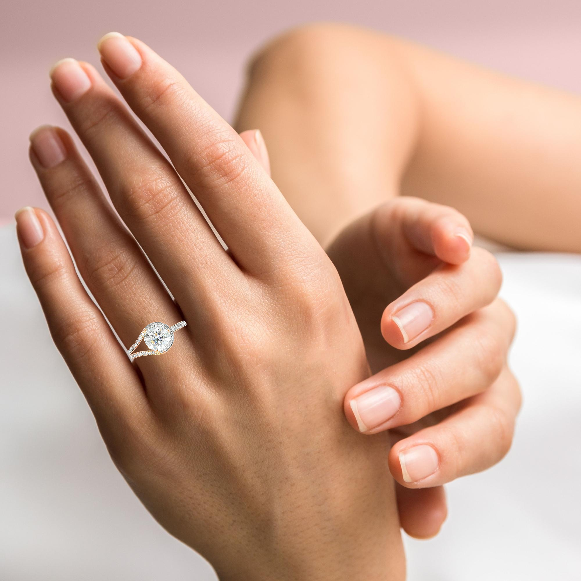 Model wearing round diamond bypass ring modern engagement design