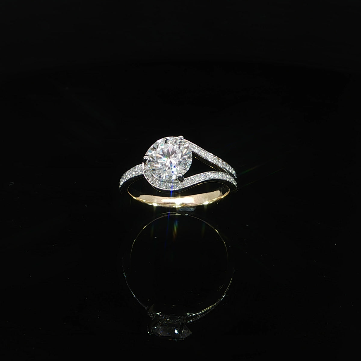 Angled view of a 1.51 carat round diamond engagement ring with curved pavé bypass bands.
