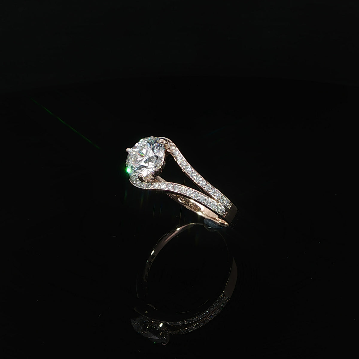 14K rose gold bypass engagement ring with a 1.54 carat round lab grown diamond and pavé diamond accents.