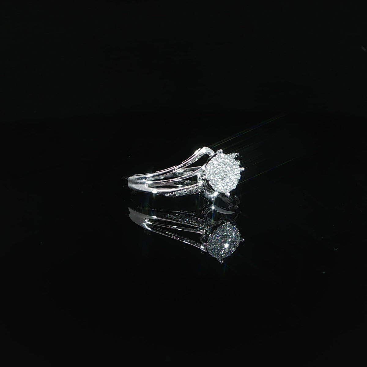 Resting profile of a 10K gold 0.07 CTW engagement ring highlighting its sculpted shoulders and open setting.