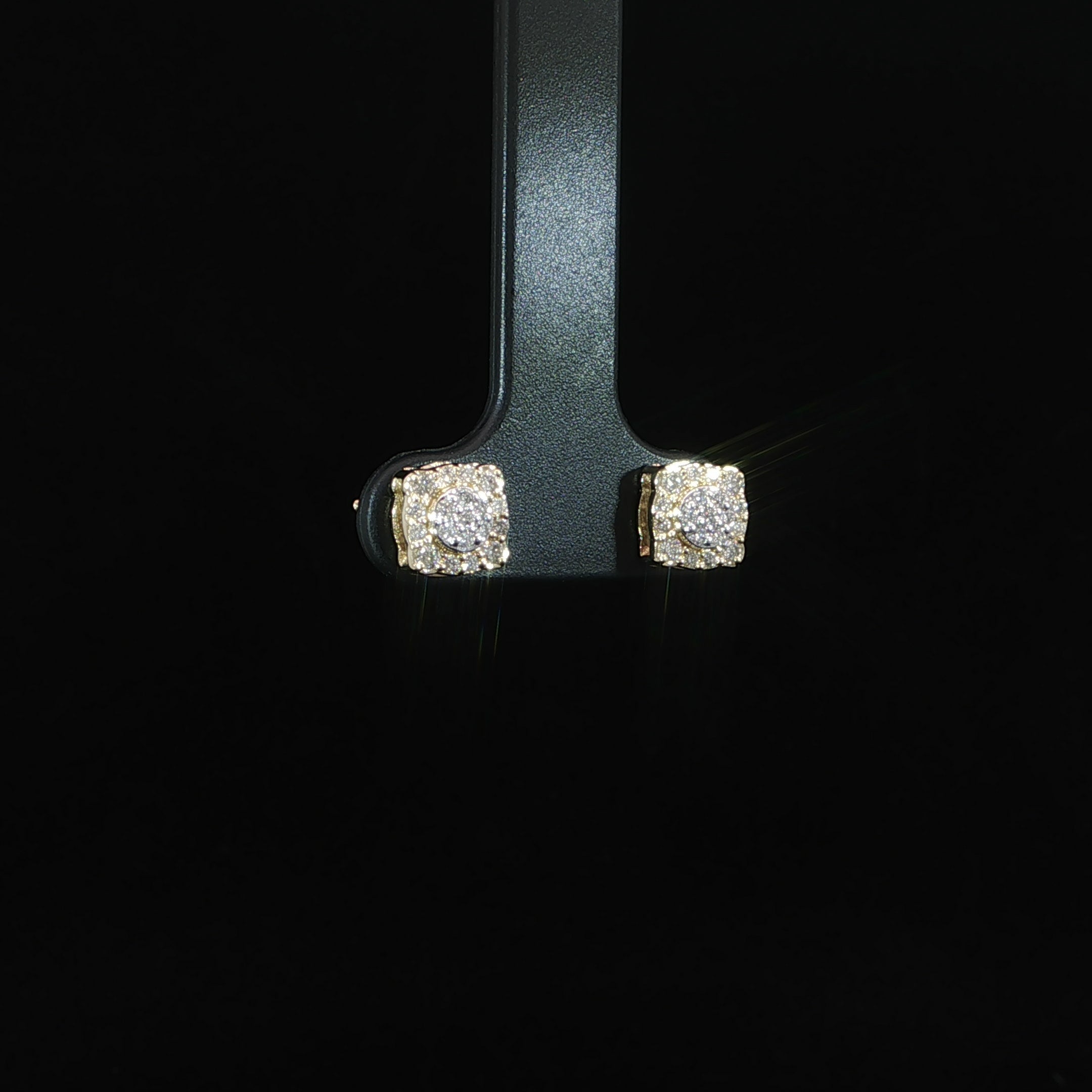 Angle view cushion diamond cluster earrings in 10K yellow gold
