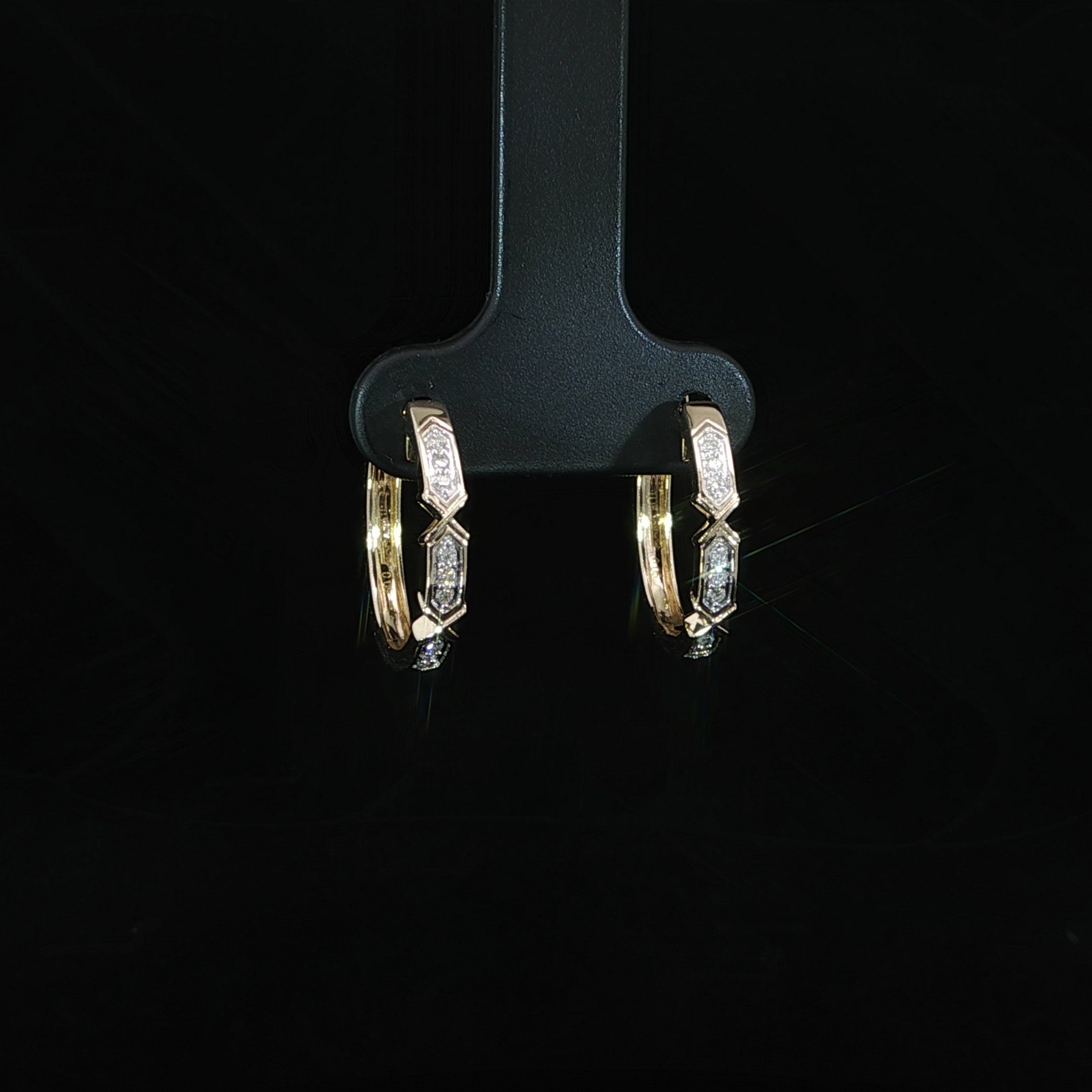 Side profile of diamond huggie earrings crafted in 10K yellow gold