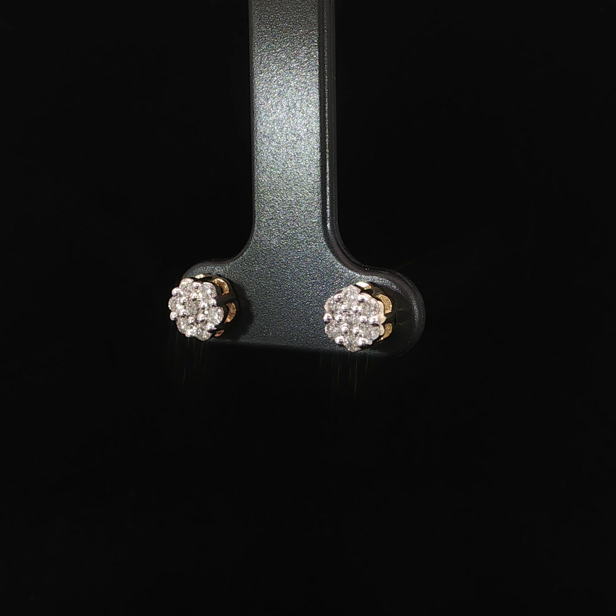 Side view of round diamond cluster earrings in 10K yellow gold