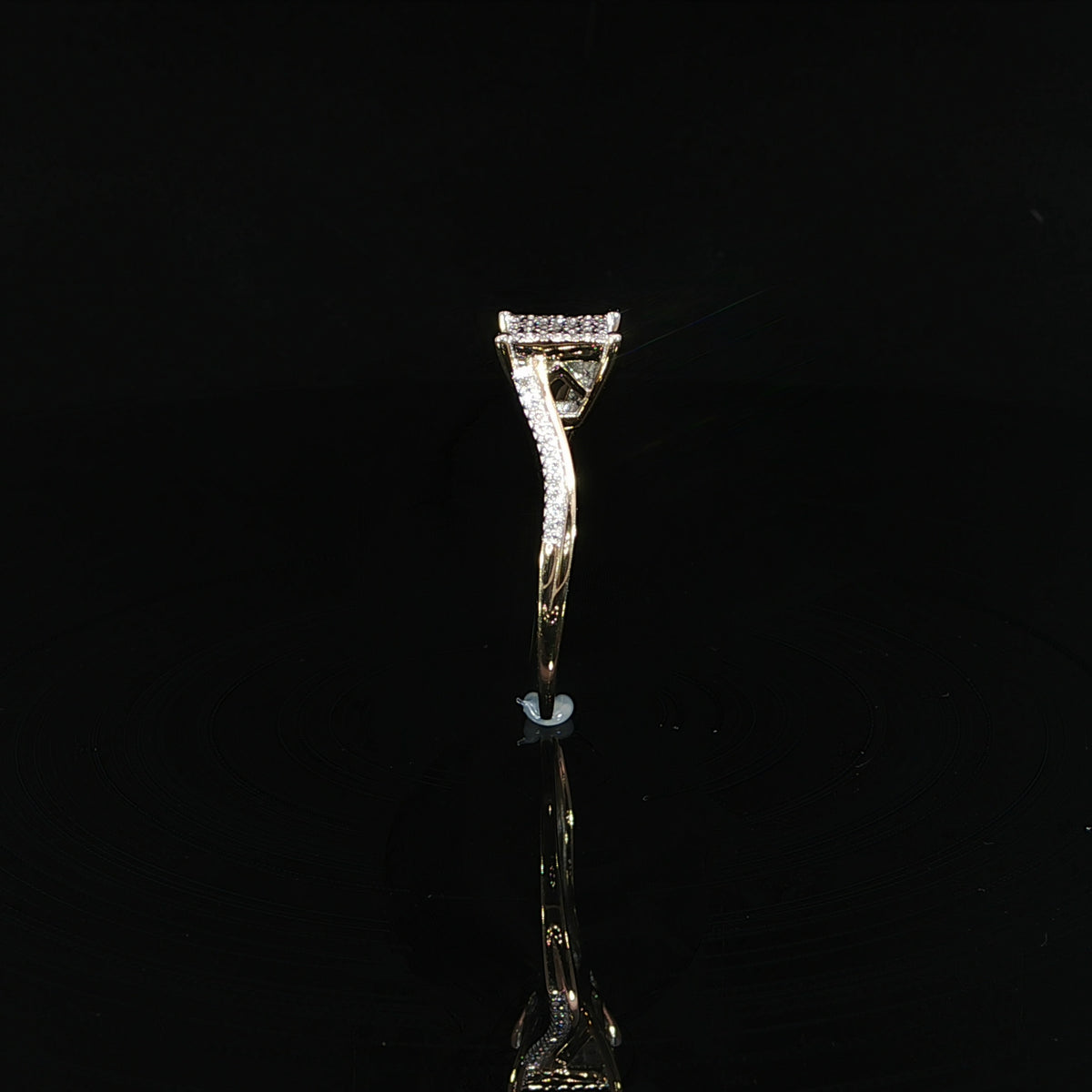 Standing side angle of a 10K yellow gold diamond cluster ring with a raised setting and open gallery.