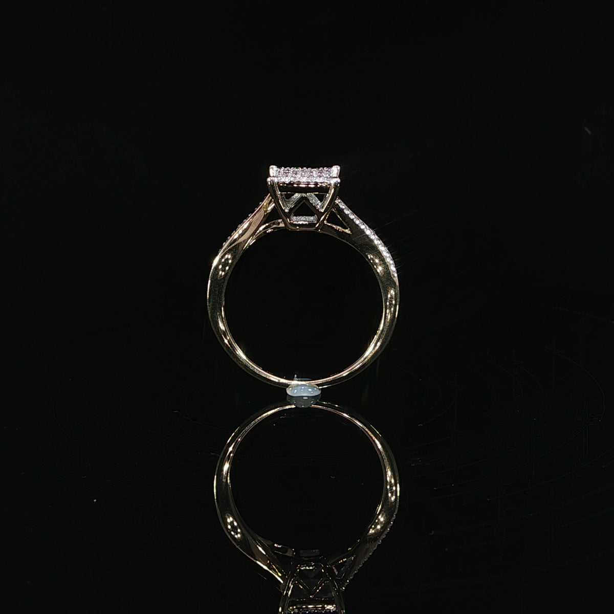 Angled profile of a 0.11 CTW diamond ring with an open yellow gold gallery beneath the cluster.