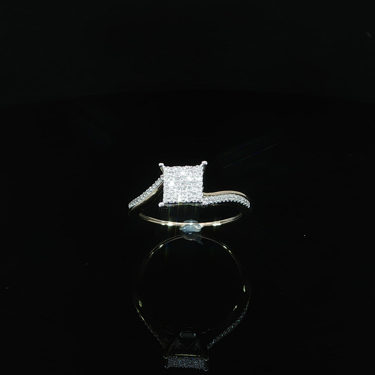 Front angle of a 10K yellow gold square cluster ring with curved diamond-accented shoulders, totaling 0.11 CTW.