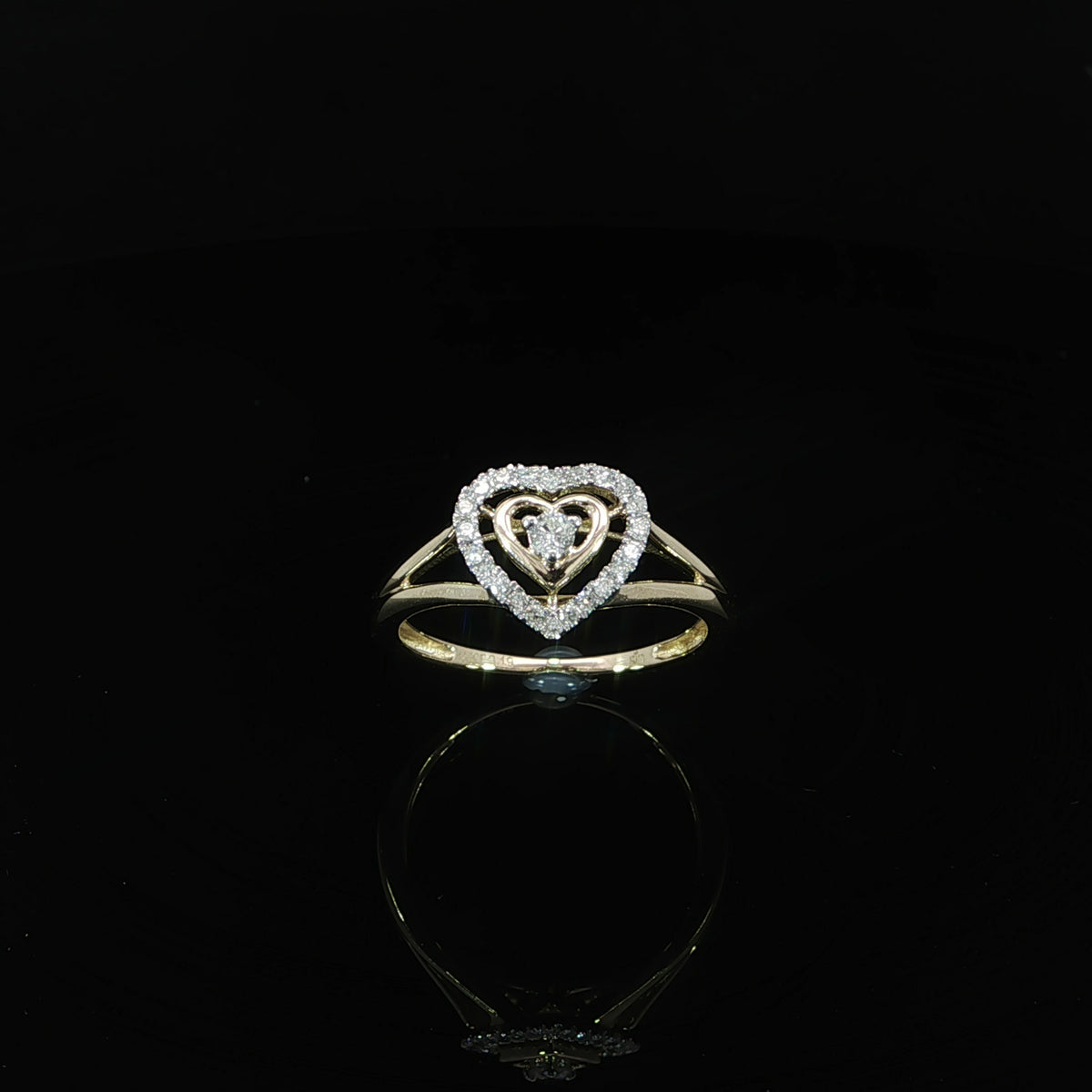 Upright view of a 10K yellow gold 0.19 CTW diamond heart ring with a raised center and halo.