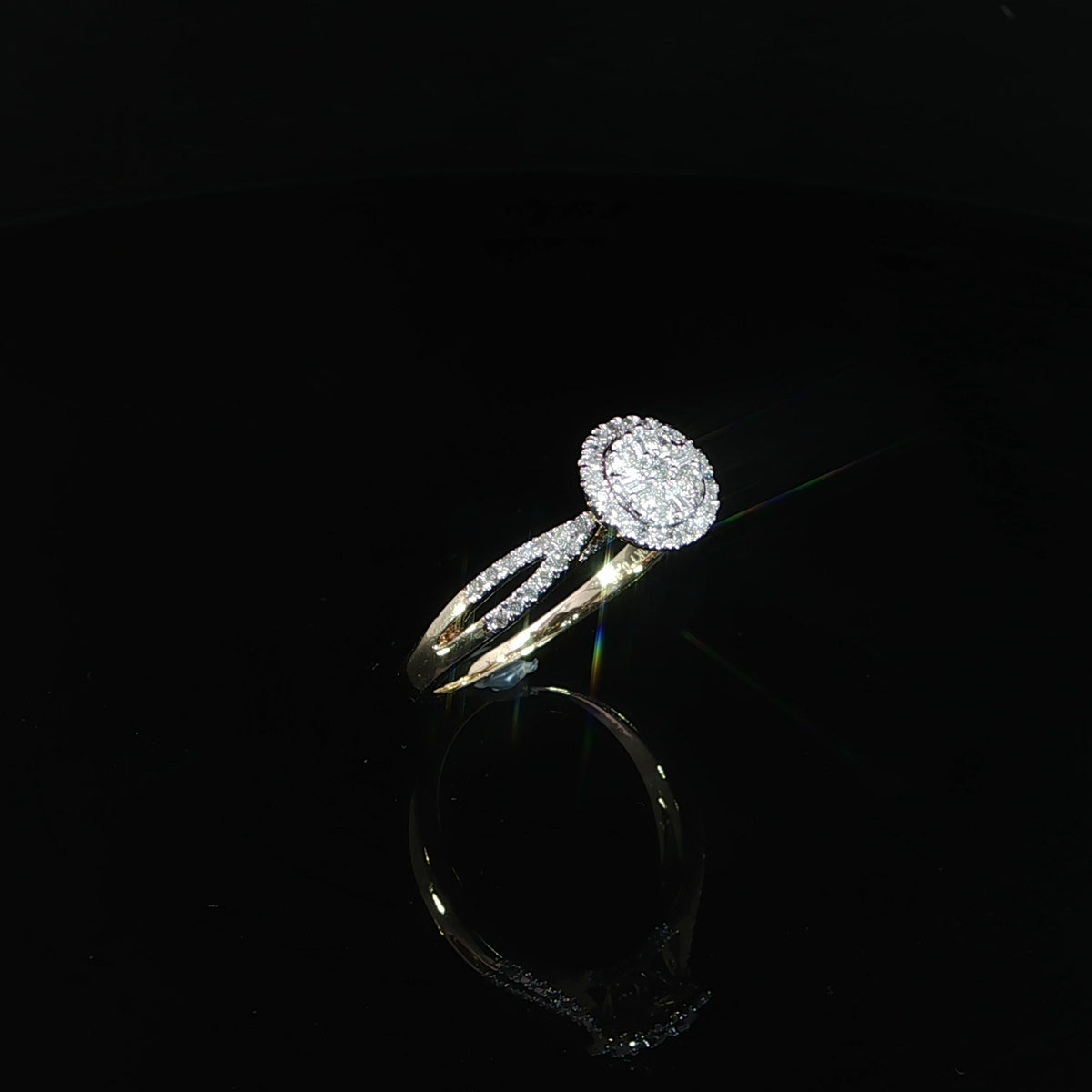 10K yellow gold 0.40 CTW round cluster halo ring tilted to show the setting and polished band.