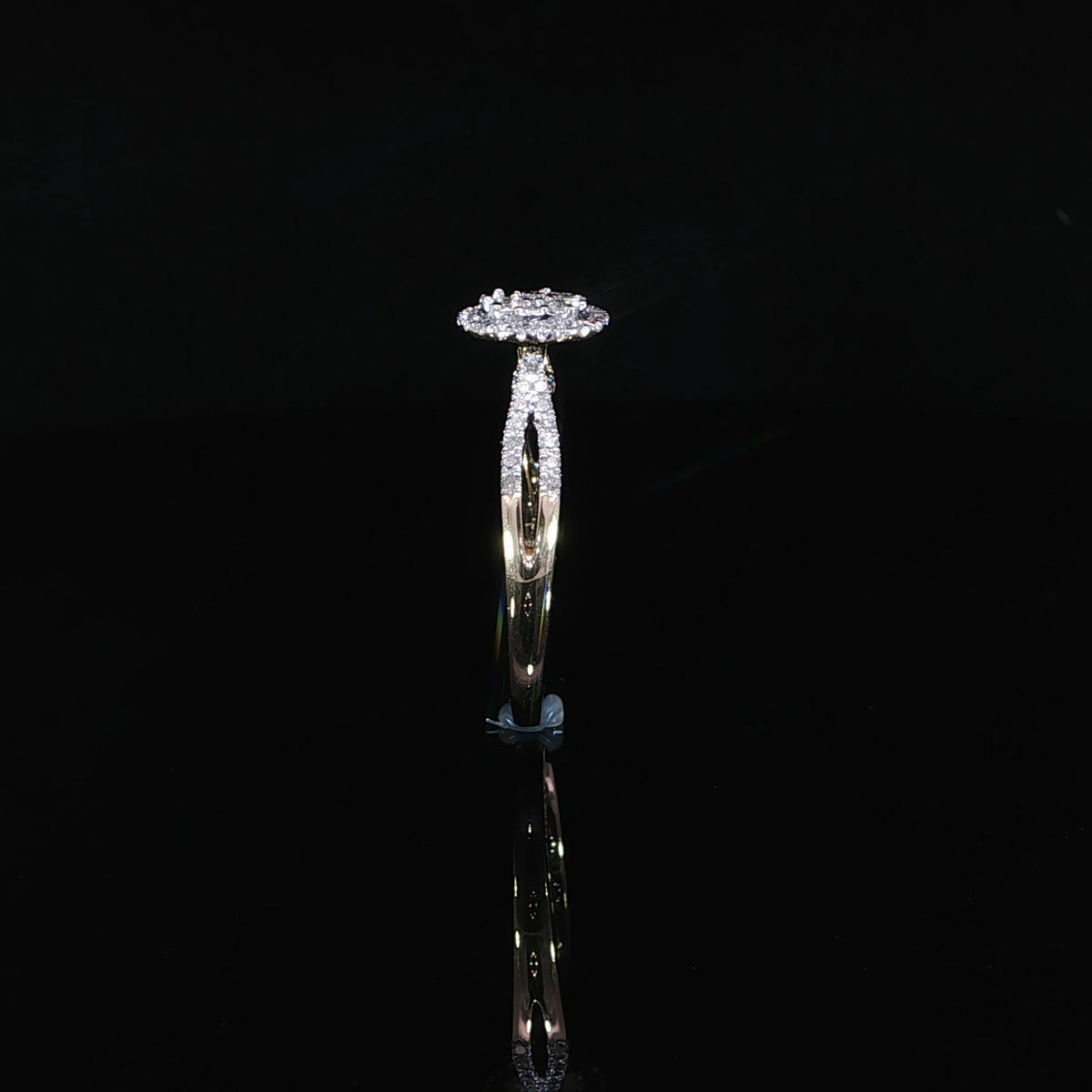 10K yellow gold 0.40 CTW diamond ring standing upright, showing its raised halo and polished lower band.