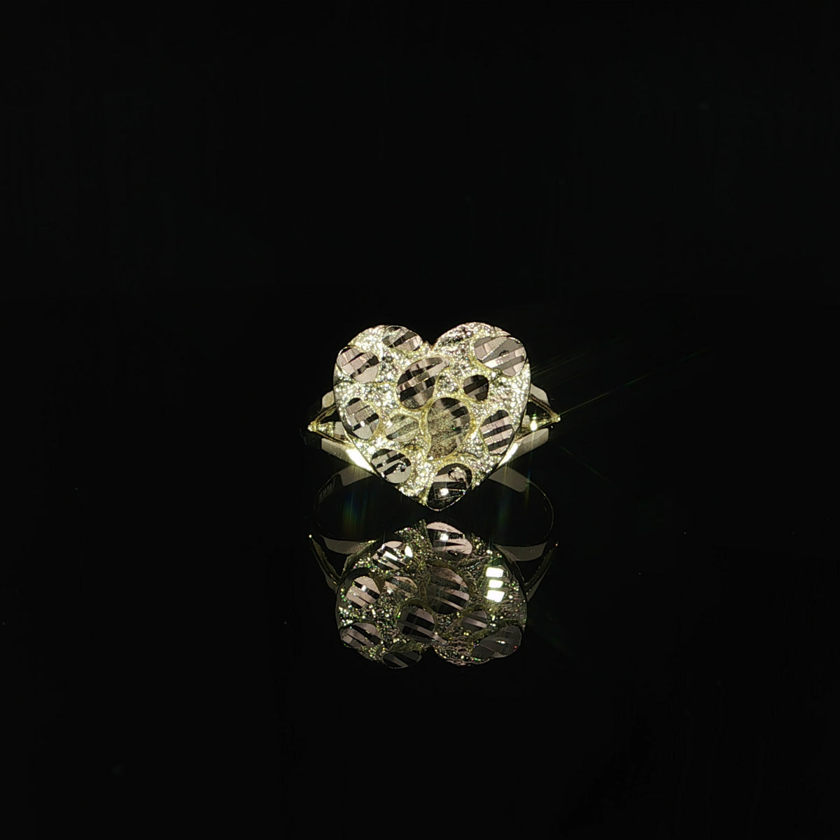 Heart-shaped yellow gold nugget ring with triangular openings at each shoulder.
