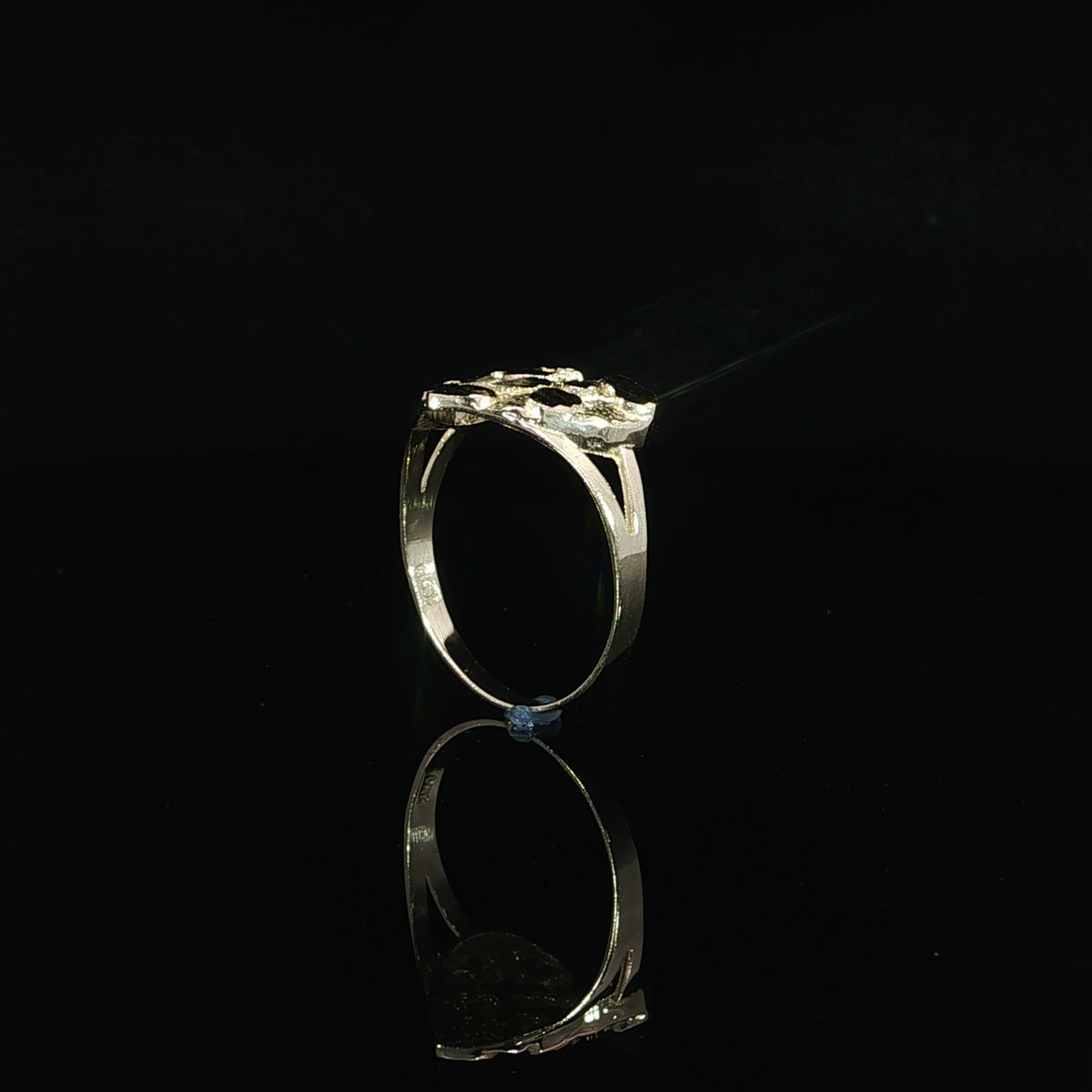 Split shoulder supporting the textured heart top of a 10K yellow gold ring.