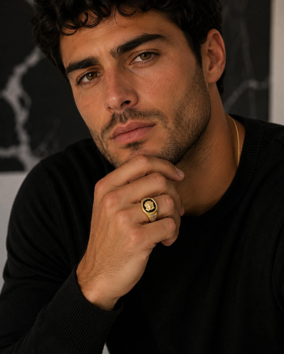 Model wearing signet ring with crown of thorns