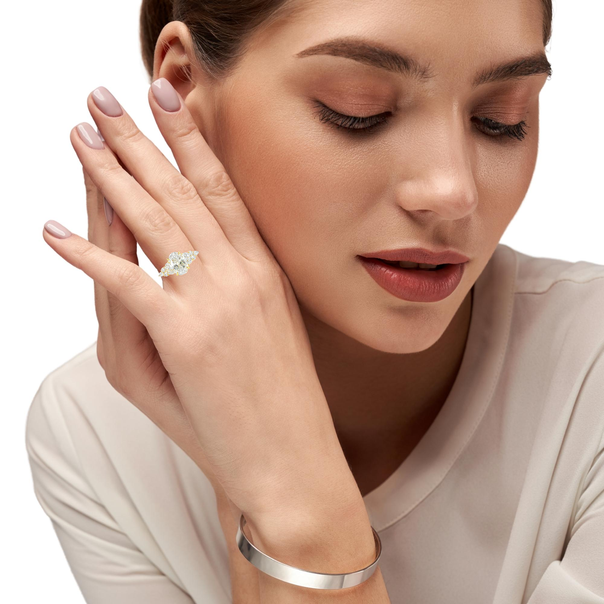 Model wearing oval diamond ring with side stones 2.52ctw