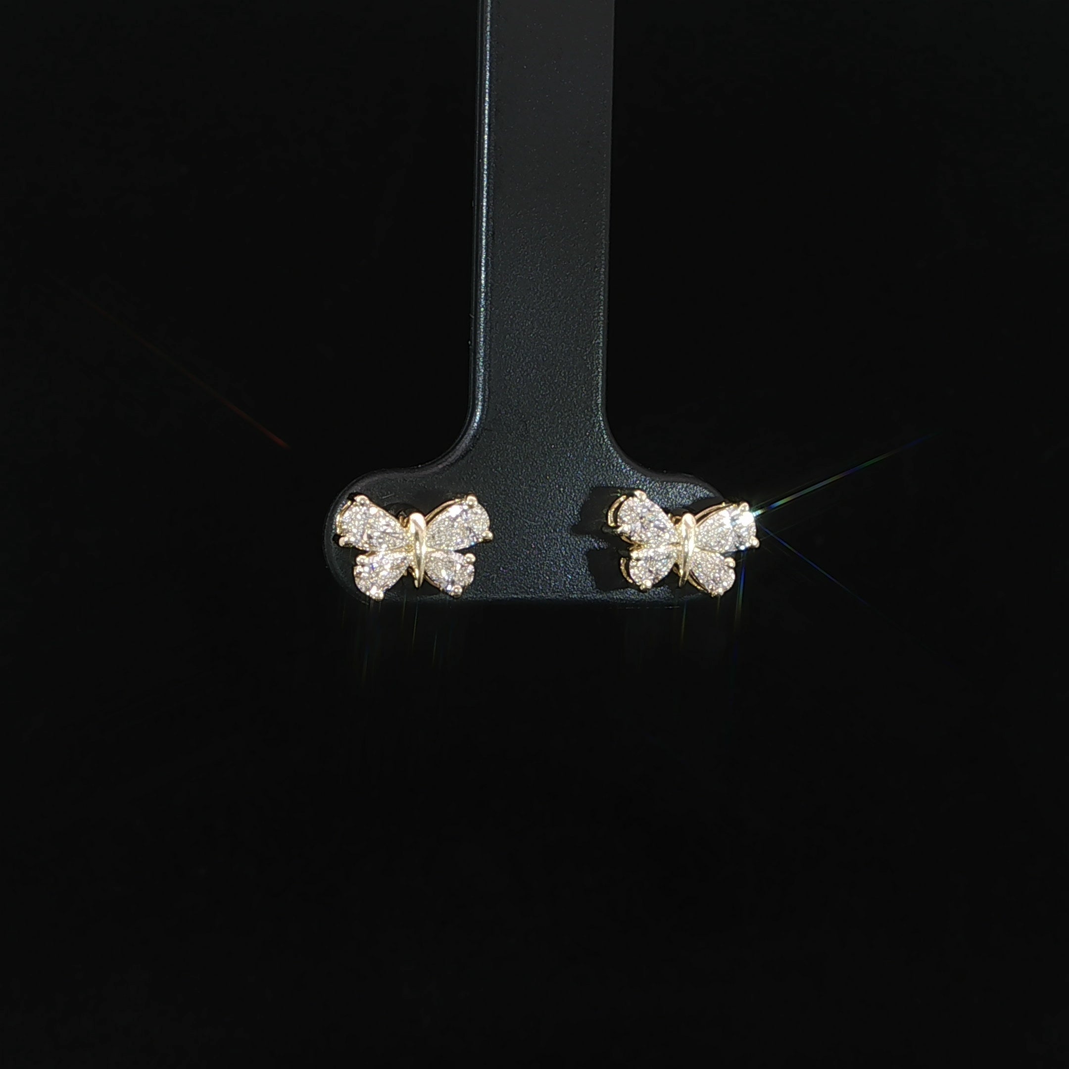 Front view of pear-cut diamond butterfly earrings in 14K yellow gold