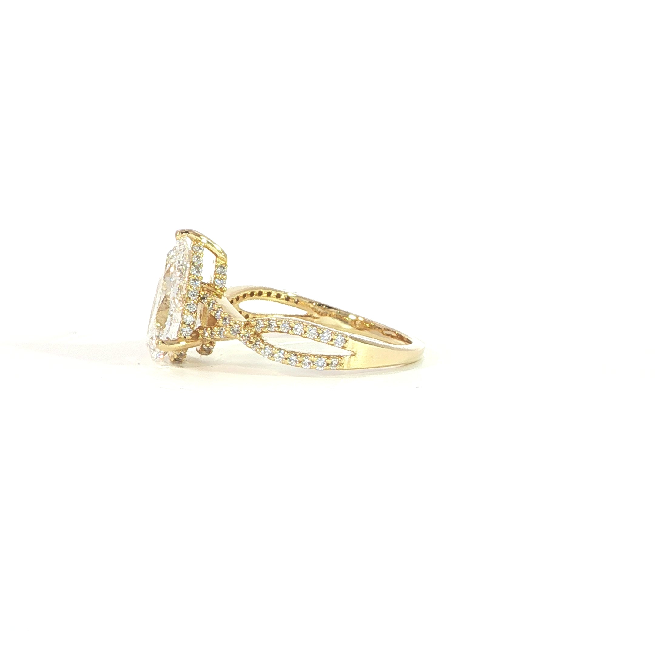 Side view of 14K gold pear engagement ring with twisted band design
