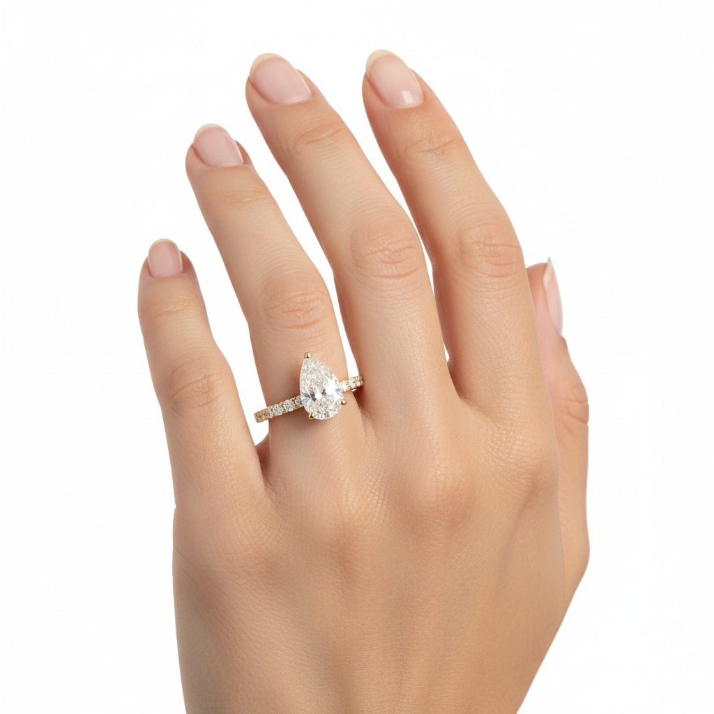 Pear-shaped diamond engagement ring with diamond band