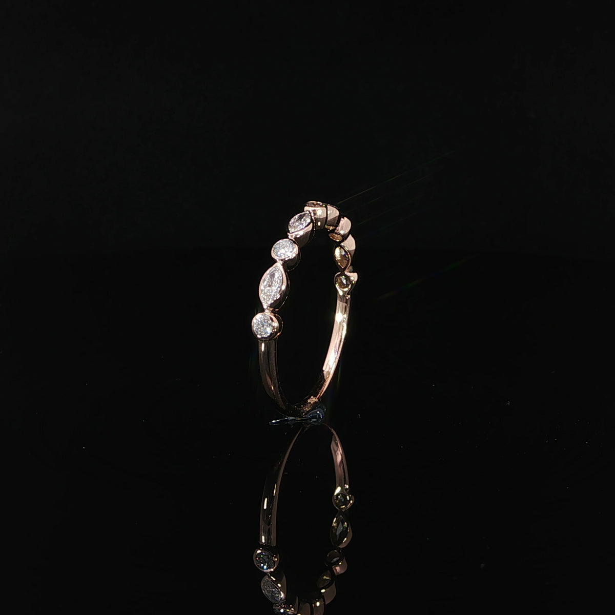 Delicate 14K rose gold stacking ring featuring 0.41 CTW lab grown diamonds in alternating marquise and round bezel settings.