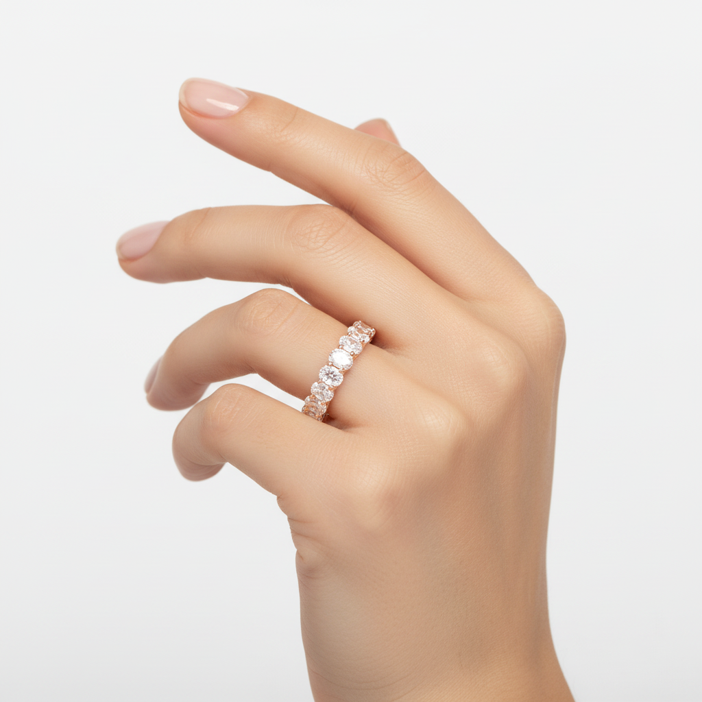 Elegant oval diamond half eternity band in 14K gold shown on model hand