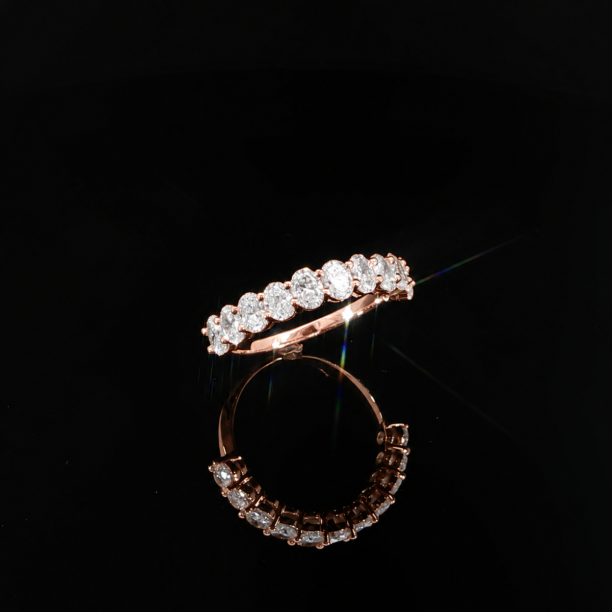 Three-quarter view of a 14K rose gold wedding band featuring 1.48 CTW of oval lab-grown diamonds.
