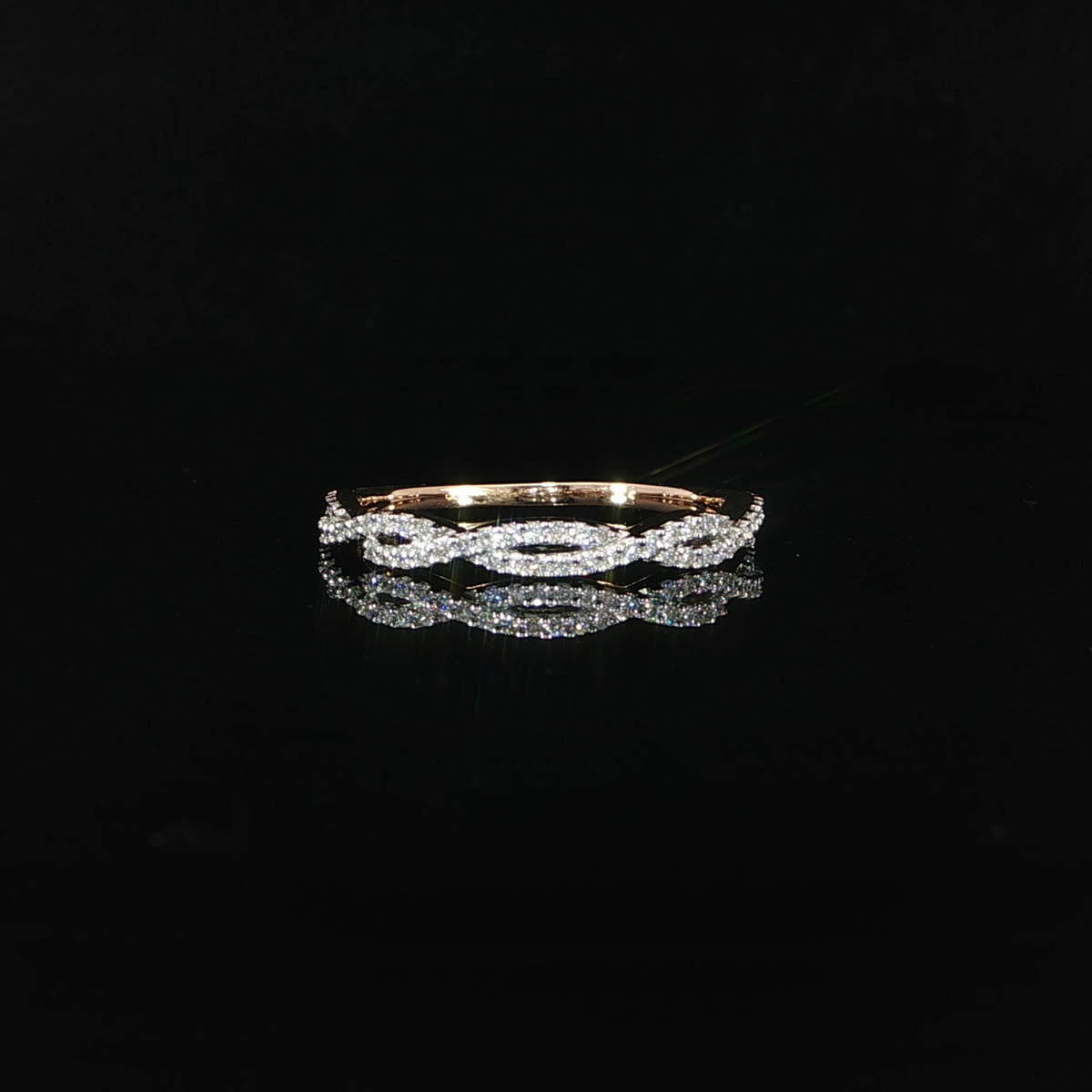 Front view of a 14K rose gold stackable twist diamond band featuring 0.23 CTW lab grown diamonds in an elegant interlocking design.