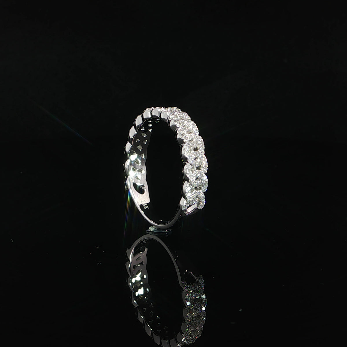 Upright side view of a 14K white gold chain-link diamond band with open detailing beneath the settings.