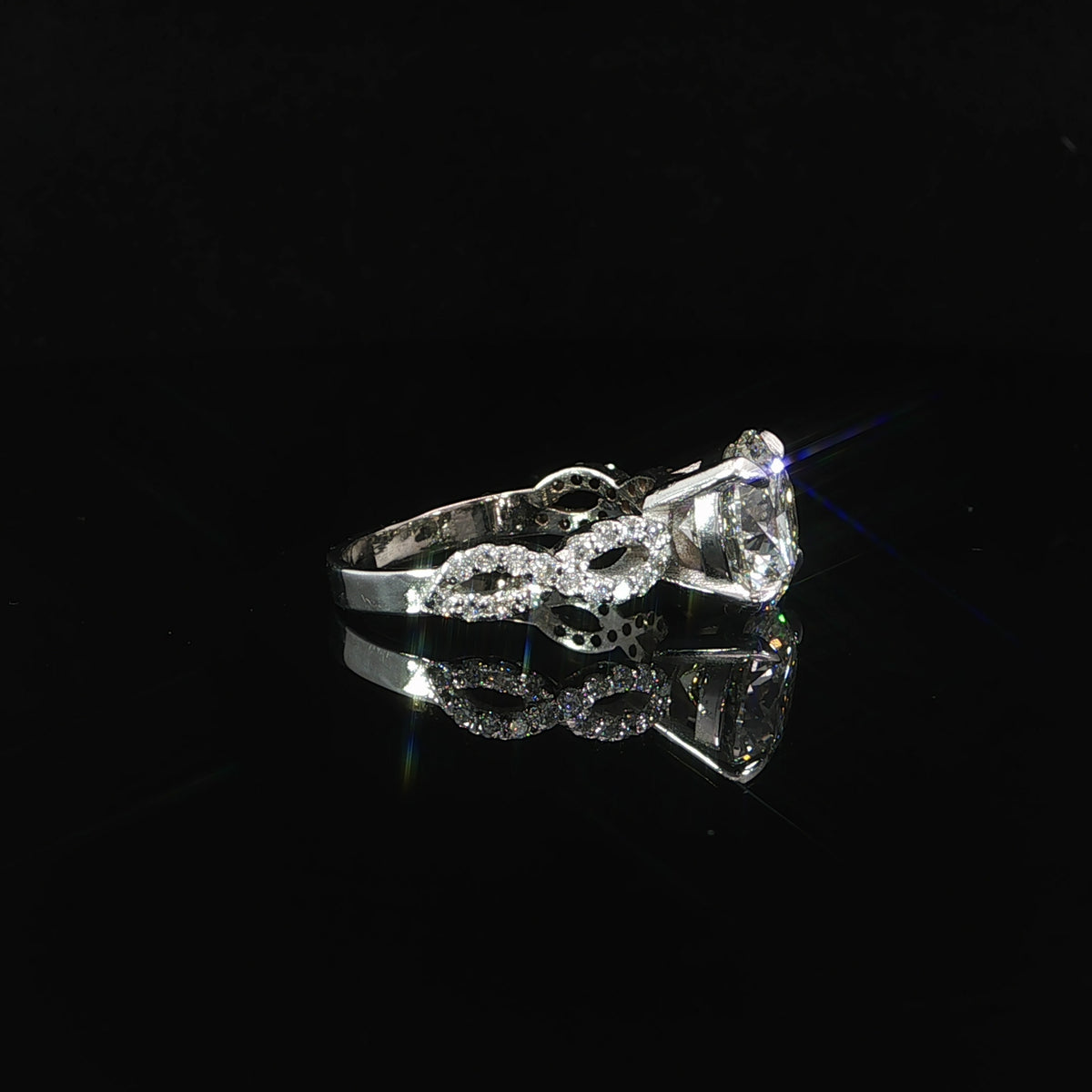 Angled view of 14K white gold infinity twist diamond engagement ring