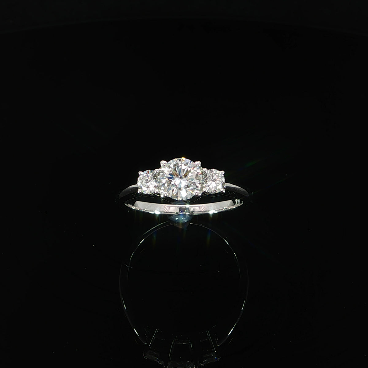White gold three-stone engagement ring with 1.03 CTW of lab grown round diamonds.