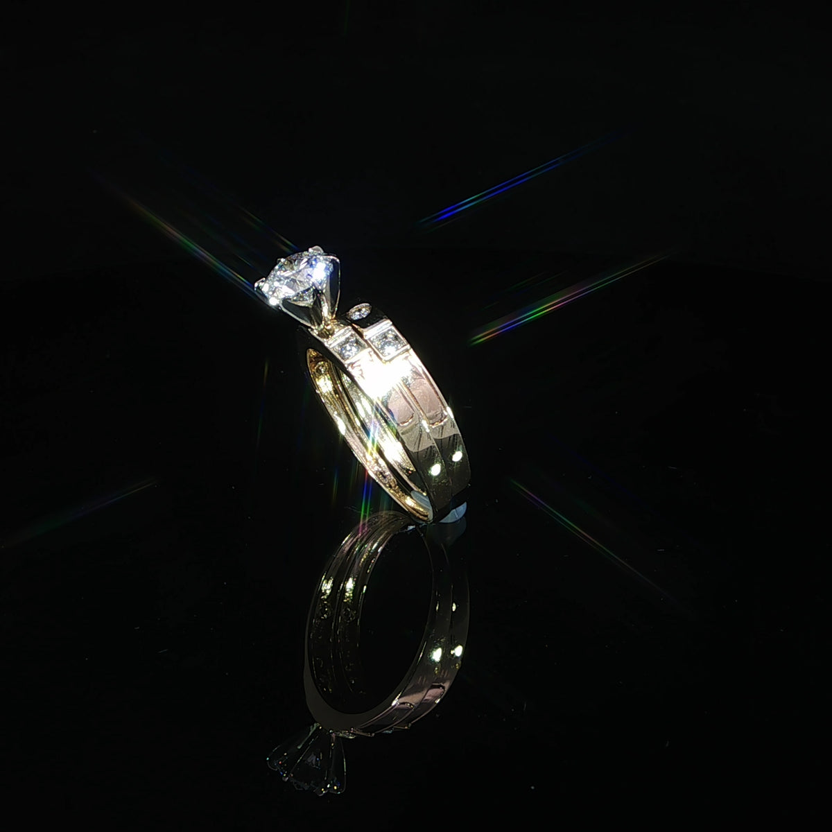 Tilted side profile of a 14K yellow gold bridal set with a raised solitaire and diamond accent shoulders.