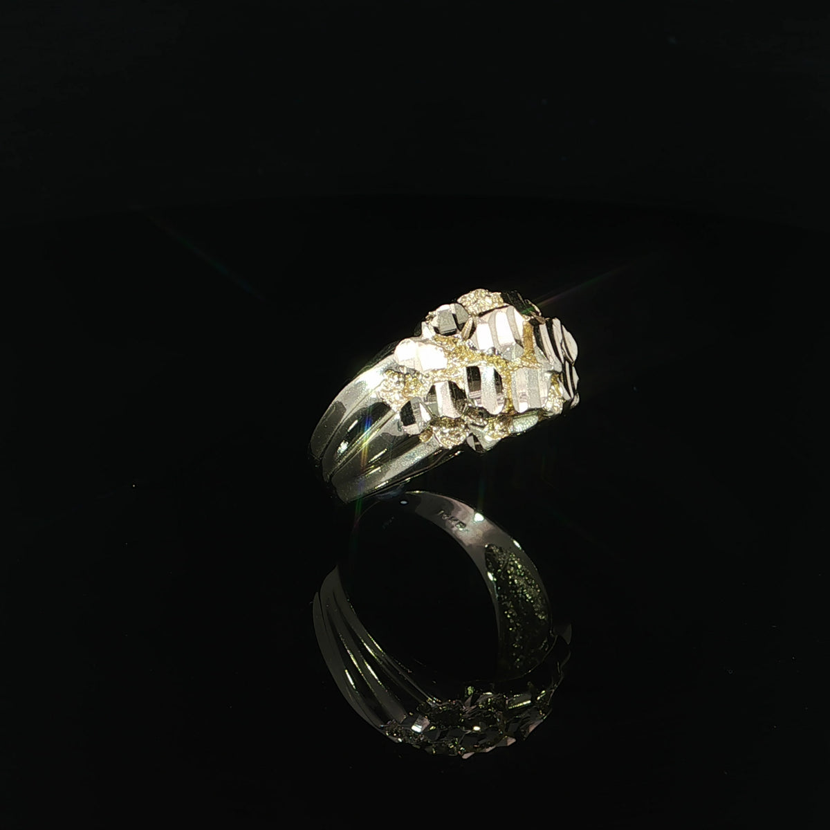 Right side angled view of a 14K yellow gold nugget ring showcasing its raised diamond-cut texture, polished tapered shank, and wide statement design.
