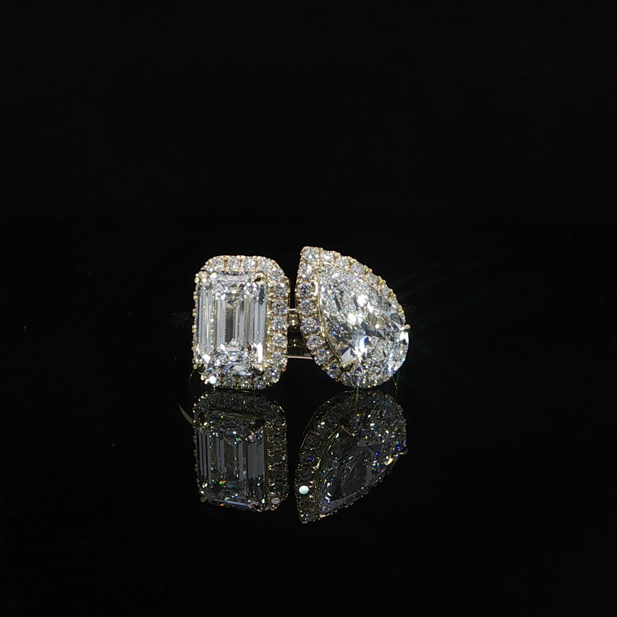 3.30 CTW Toi et Moi diamond ring with a 1.55 carat emerald cut diamond and 1.32 carat pear shaped diamond.