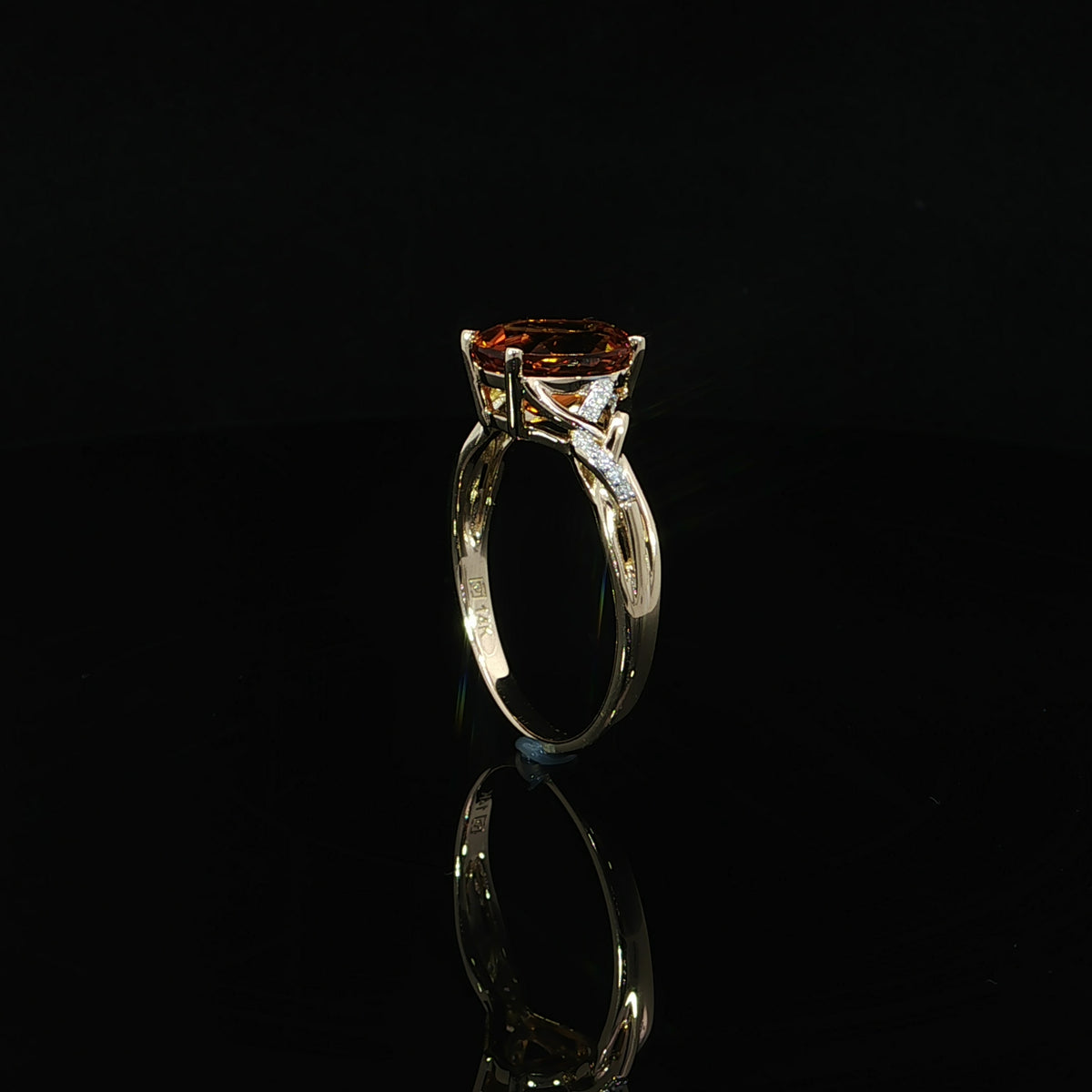 Natural citrine ring in 14K yellow gold showing open twisted shoulders accented with 0.06 CTW diamonds.