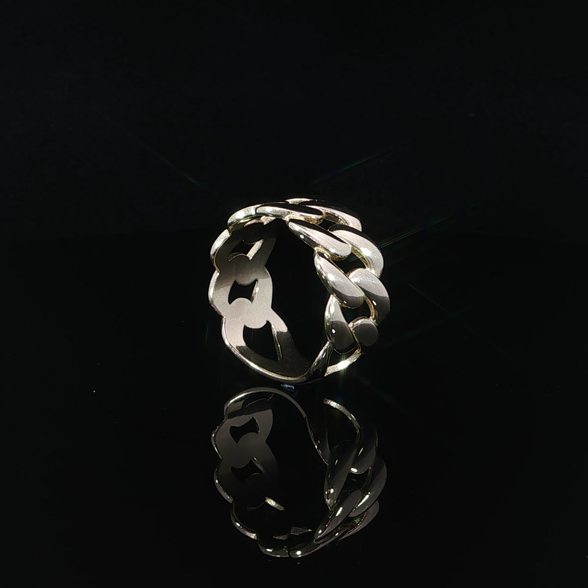 Side profile of a 14K yellow gold Cuban link ring showcasing the dimensional chain links, open spaces between the links, and smooth interior band.