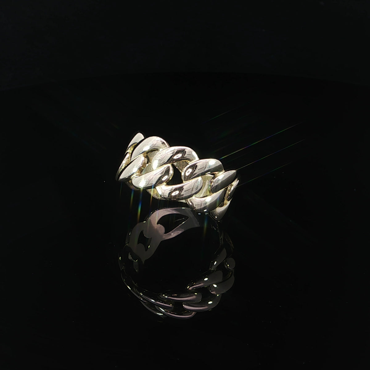 Three-quarter angled view of a 14K yellow gold Cuban link ring showcasing its raised interlocking links and smooth polished band underneath.