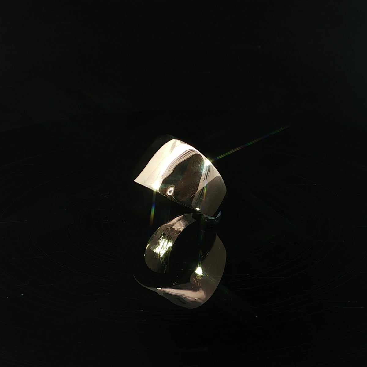 Angled view of a 14K yellow gold dome ring with a high polish finish
