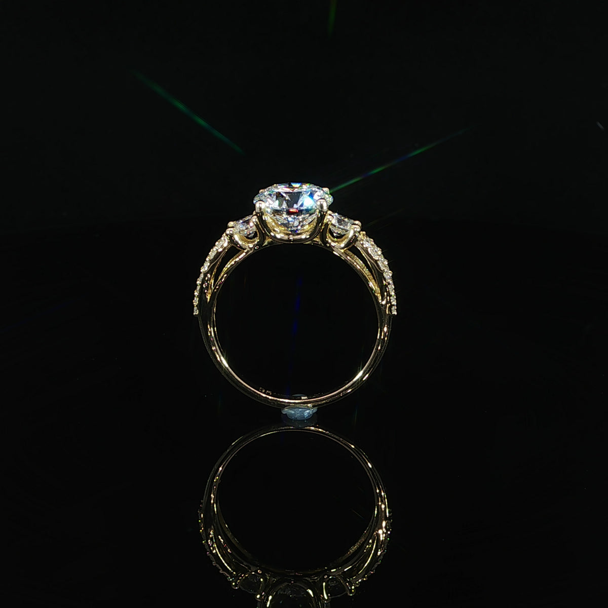 Gallery beneath the round center diamond in a 14K yellow gold engagement ring
