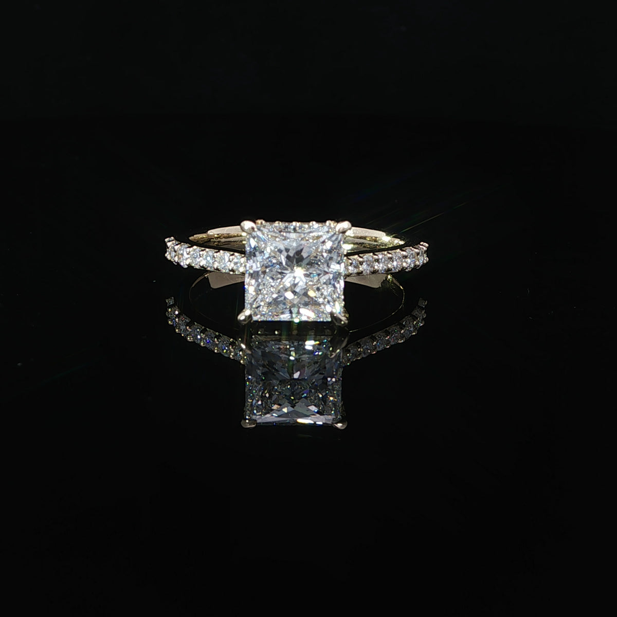14K yellow gold engagement ring with a 2.02 carat princess cut lab grown diamond, pavé band, and hidden halo.