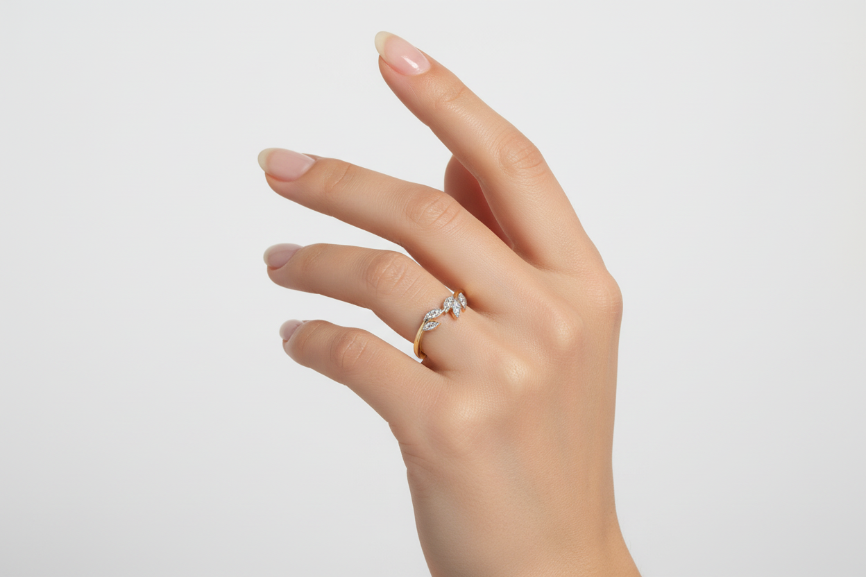 Stackable 14K gold diamond leaf ring with curved band worn by model