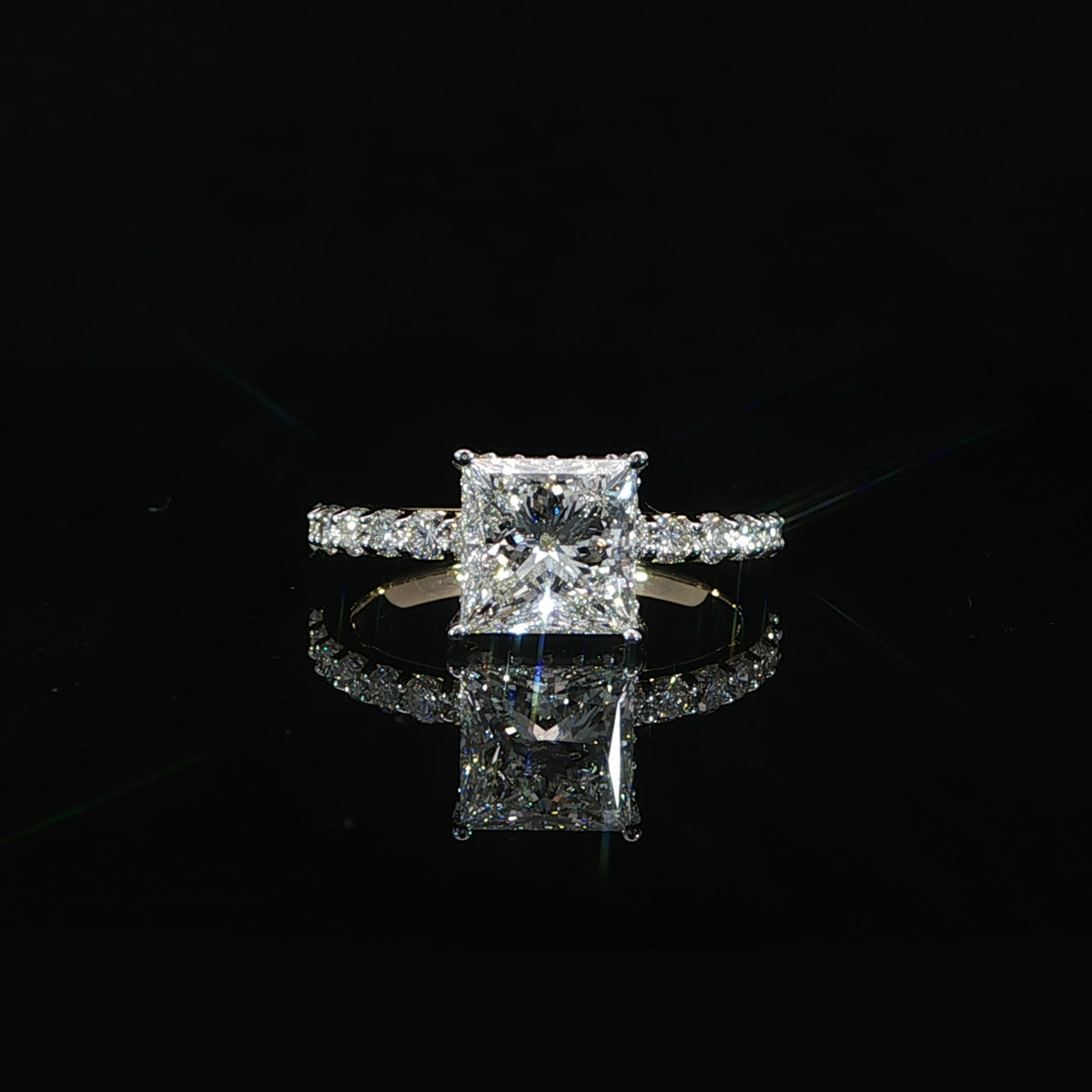 Front view of a 2.03 carat princess cut diamond engagement ring with a pavé diamond band.