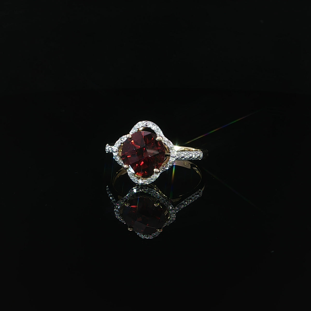 Front view of a 14K yellow gold natural red garnet ring with 0.10 CTW diamonds.