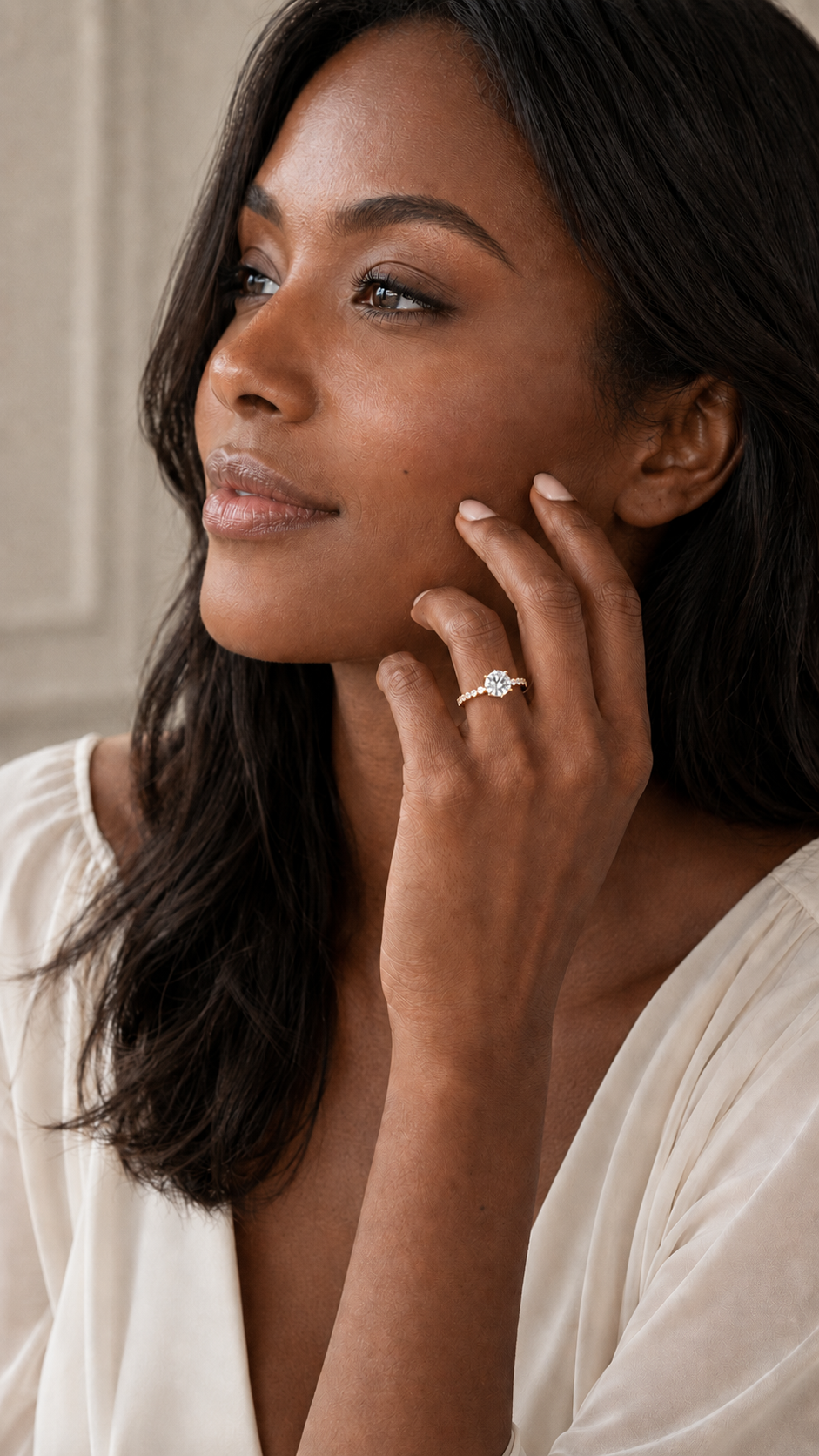 Model wearing round brilliant diamond engagement ring with hidden halo