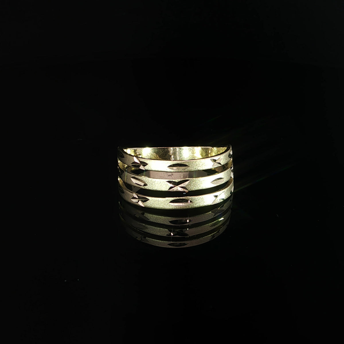 Front view of a 14K yellow gold band with three open rows and star-cut details.