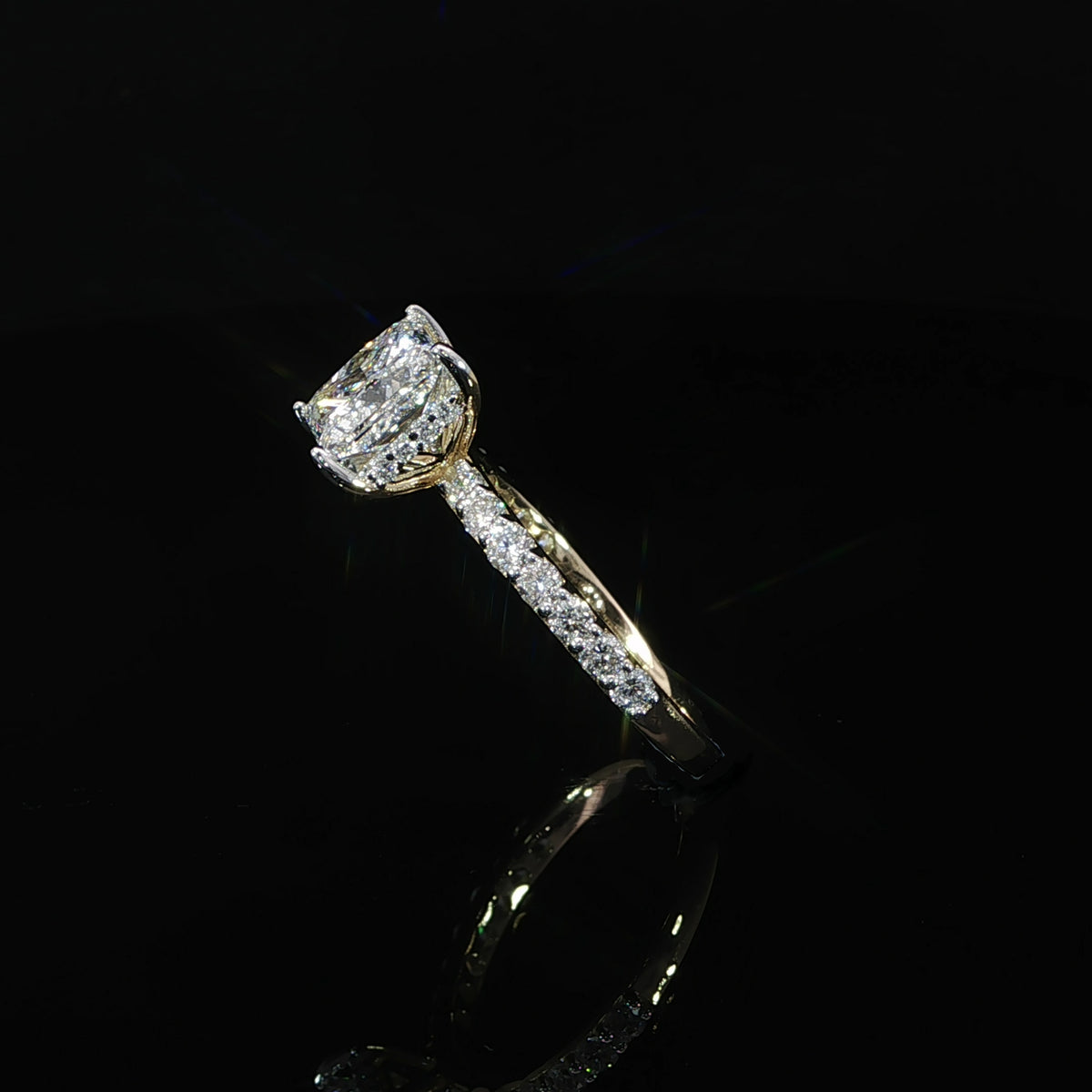 Side-angle view of a princess cut diamond ring showing the elevated setting and pavé diamond shoulders.