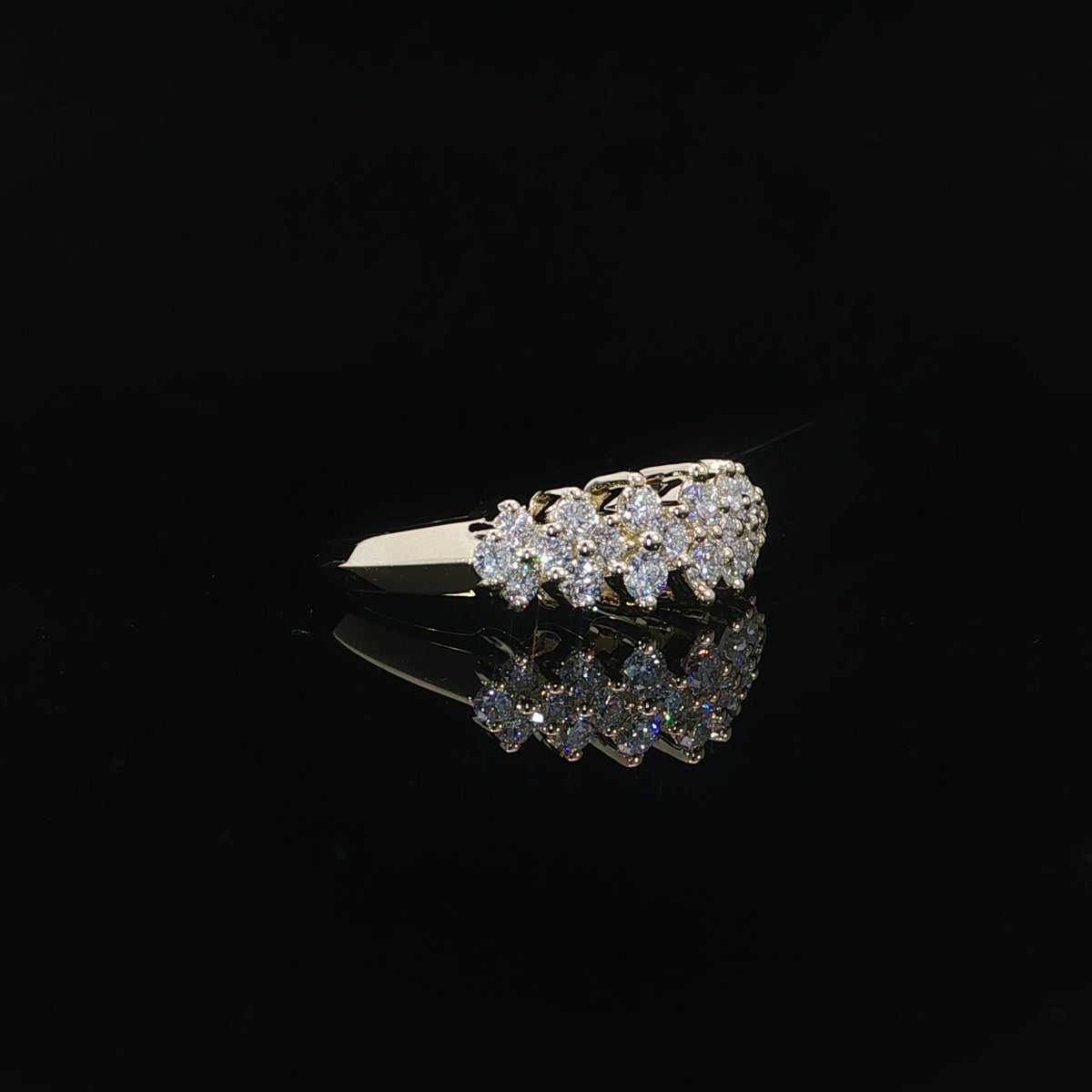 1.02 CTW lab-grown diamond band with staggered stones and visible gold prongs.