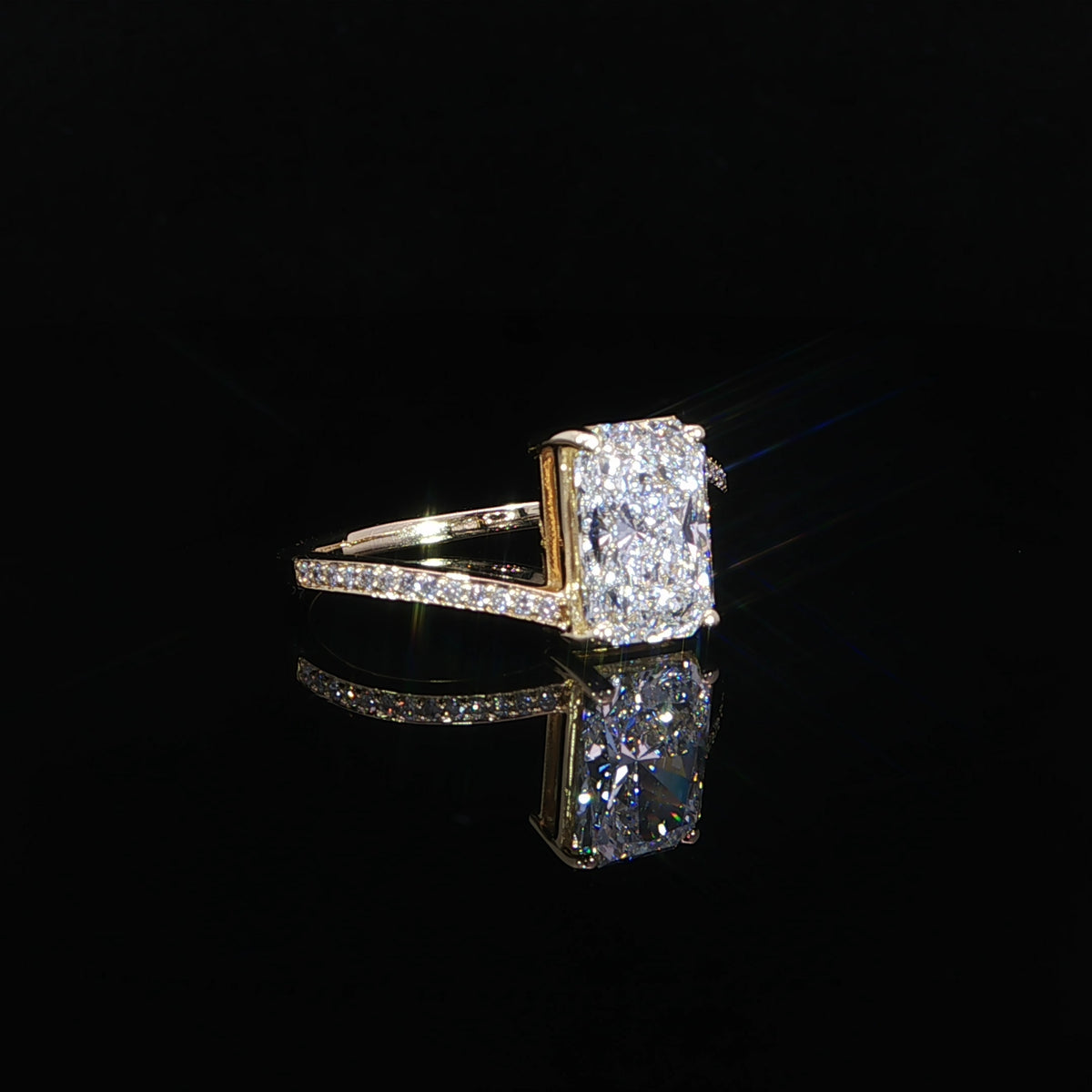 Front angle of a 2.05 carat radiant diamond ring with a yellow gold bypass band